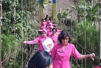 Ketua Bhayangkari Daerah Sulbar Ny Syane Verdianto Bersama Rombongan Saat Melintasi Jembatan Gantung yang Berada di Desa Botteng, Kecamatan Tapalang, Mamuju.