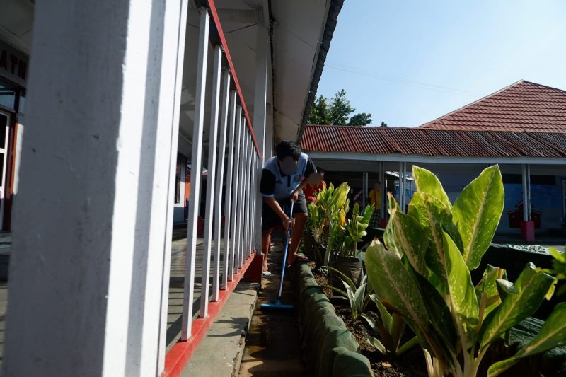 Warga Binaan sedang melakukan pembersihan area taman